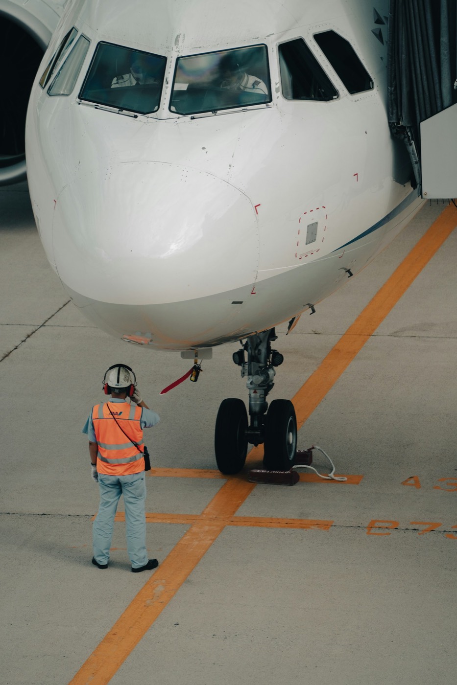 A pilot beside a single-engine airplane after a flight.
